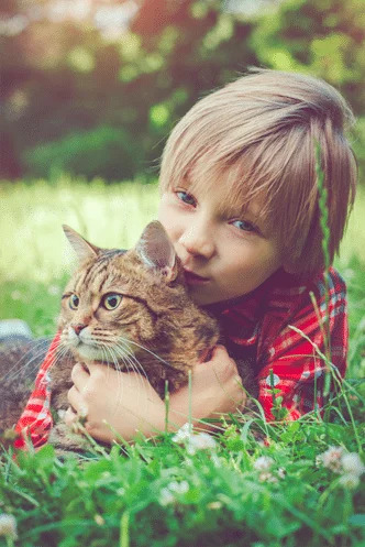 young-boy-hugging-cat-outside